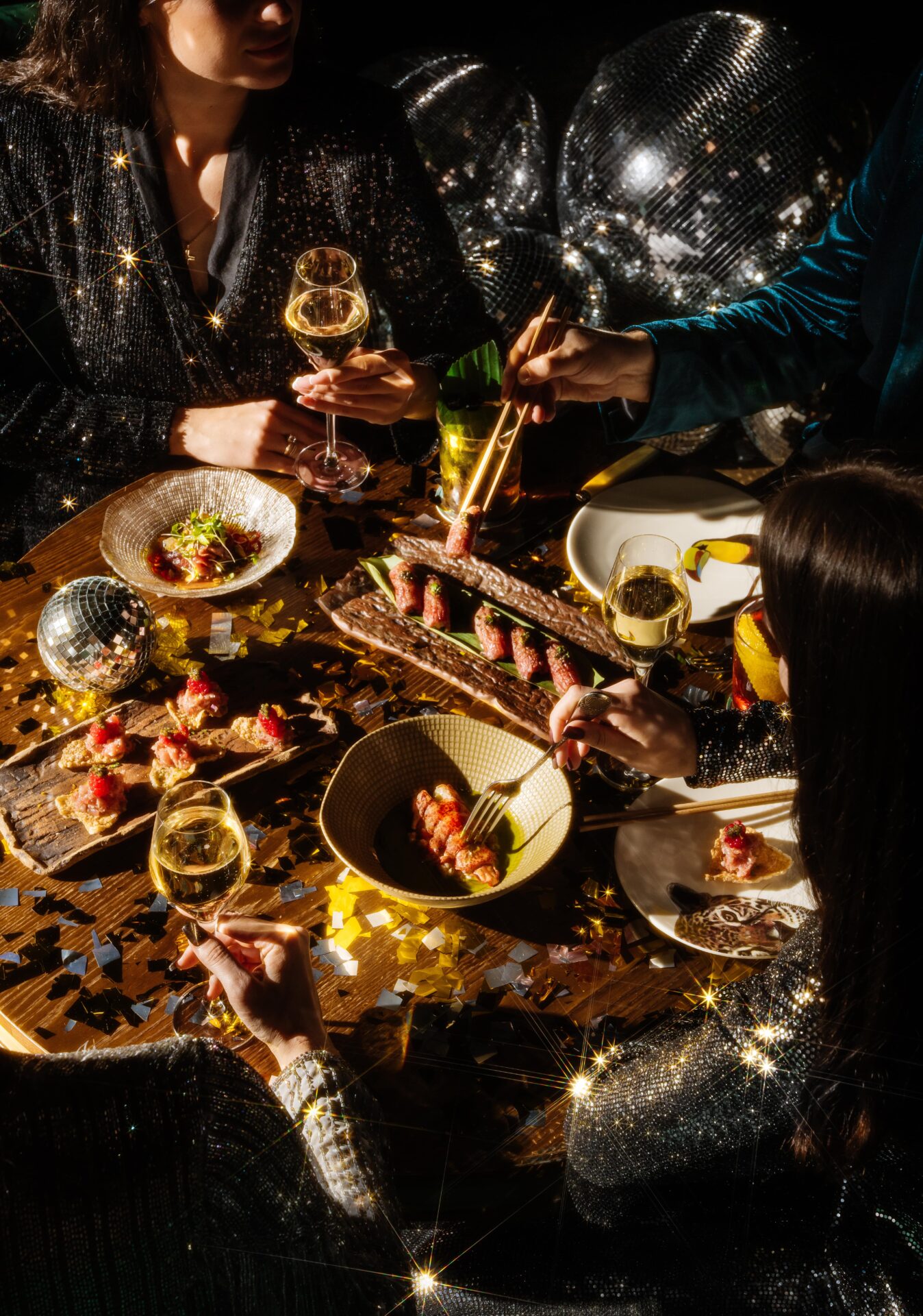 Festive dinner party with sushi, champagne, and sparkling decor