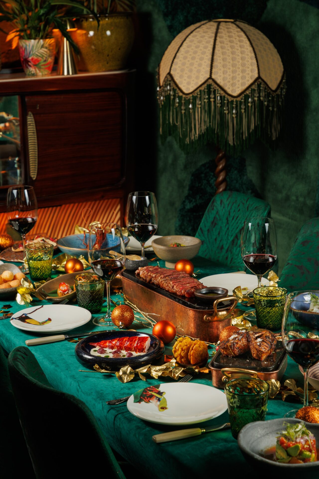 Christmas dining table with roasted meats and decorations