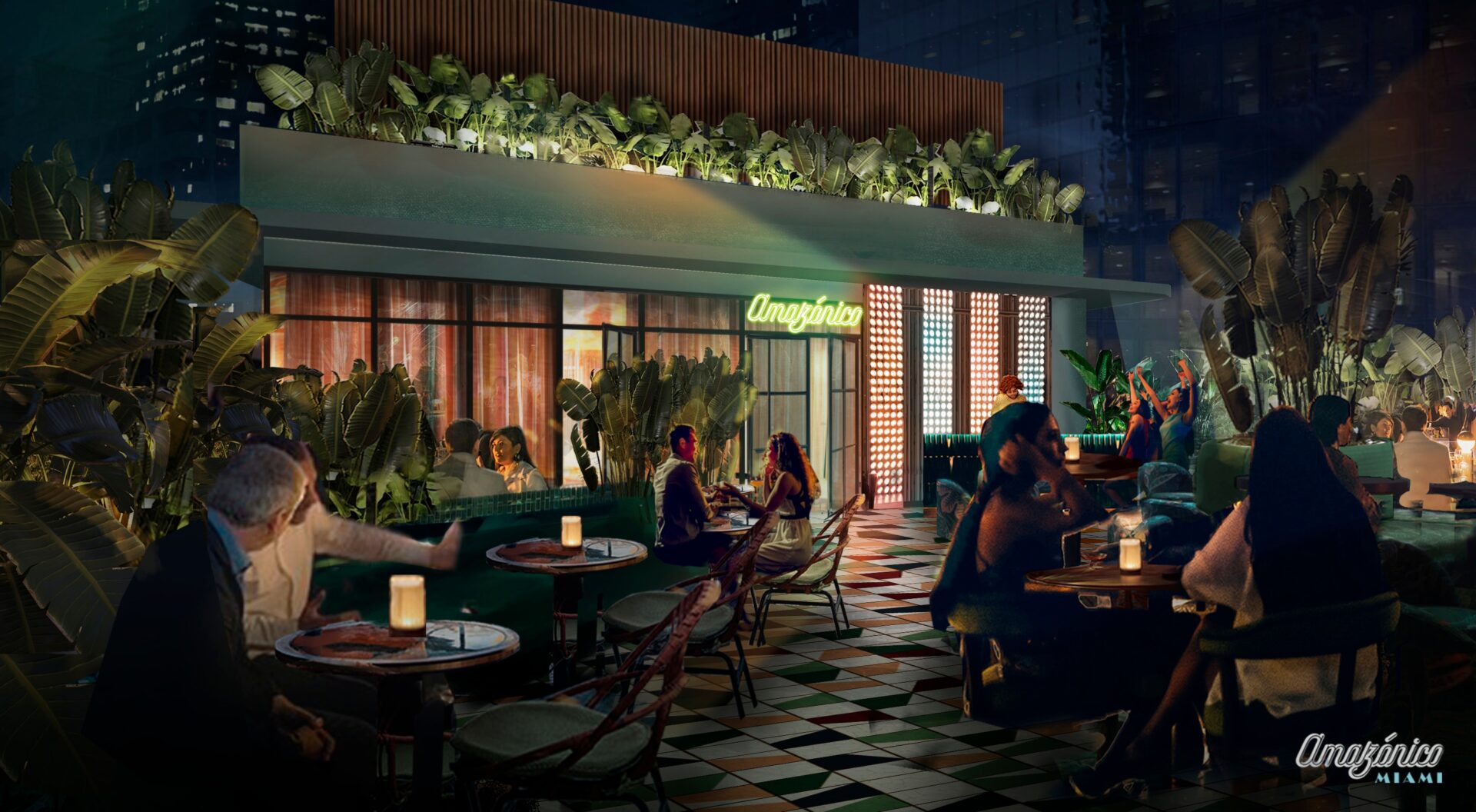 Nighttime rooftop terrace of Amazónico Miami, featuring an open-air dining area surrounded by lush tropical plants and city skyscrapers in the background. Guests sit at candle-lit tables with green and terracotta checkered tiles underfoot. A neon sign reading “Amazónico” glows above the restaurant entrance. Elegant couples and groups are engaged in conversation and dining, while a small crowd in the background enjoys live music or entertainment under ambient lighting, creating a vibrant, jungle-meets-urban atmosphere.